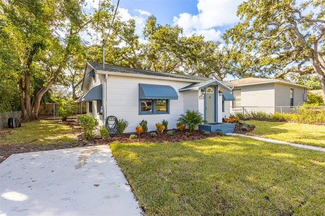 a front view of house with yard and trees around