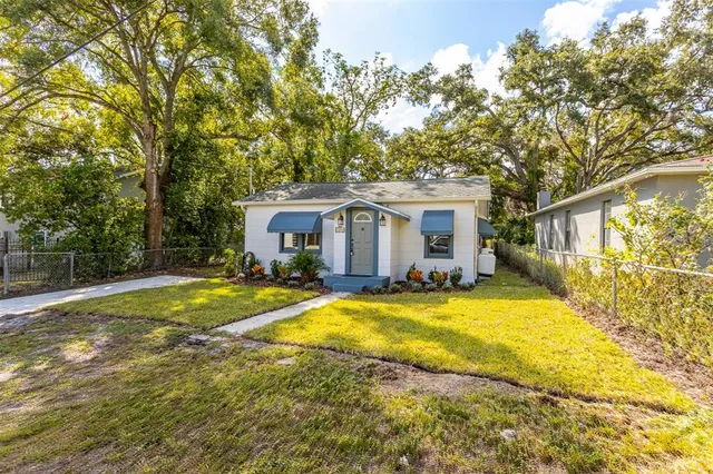 a view of a house with swimming pool and a yard