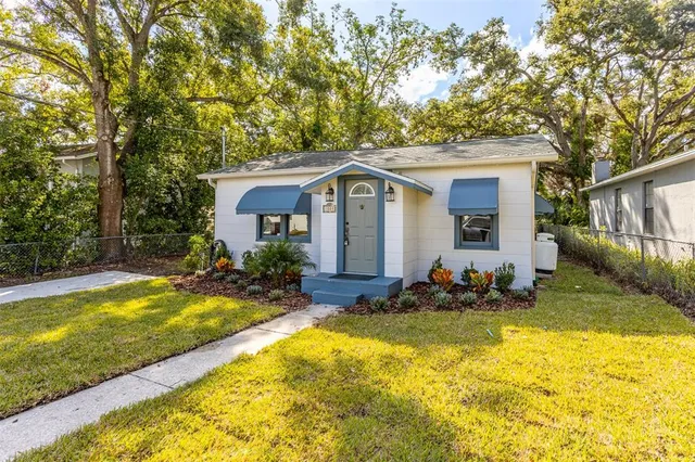 a view of a house with swimming pool and sitting area
