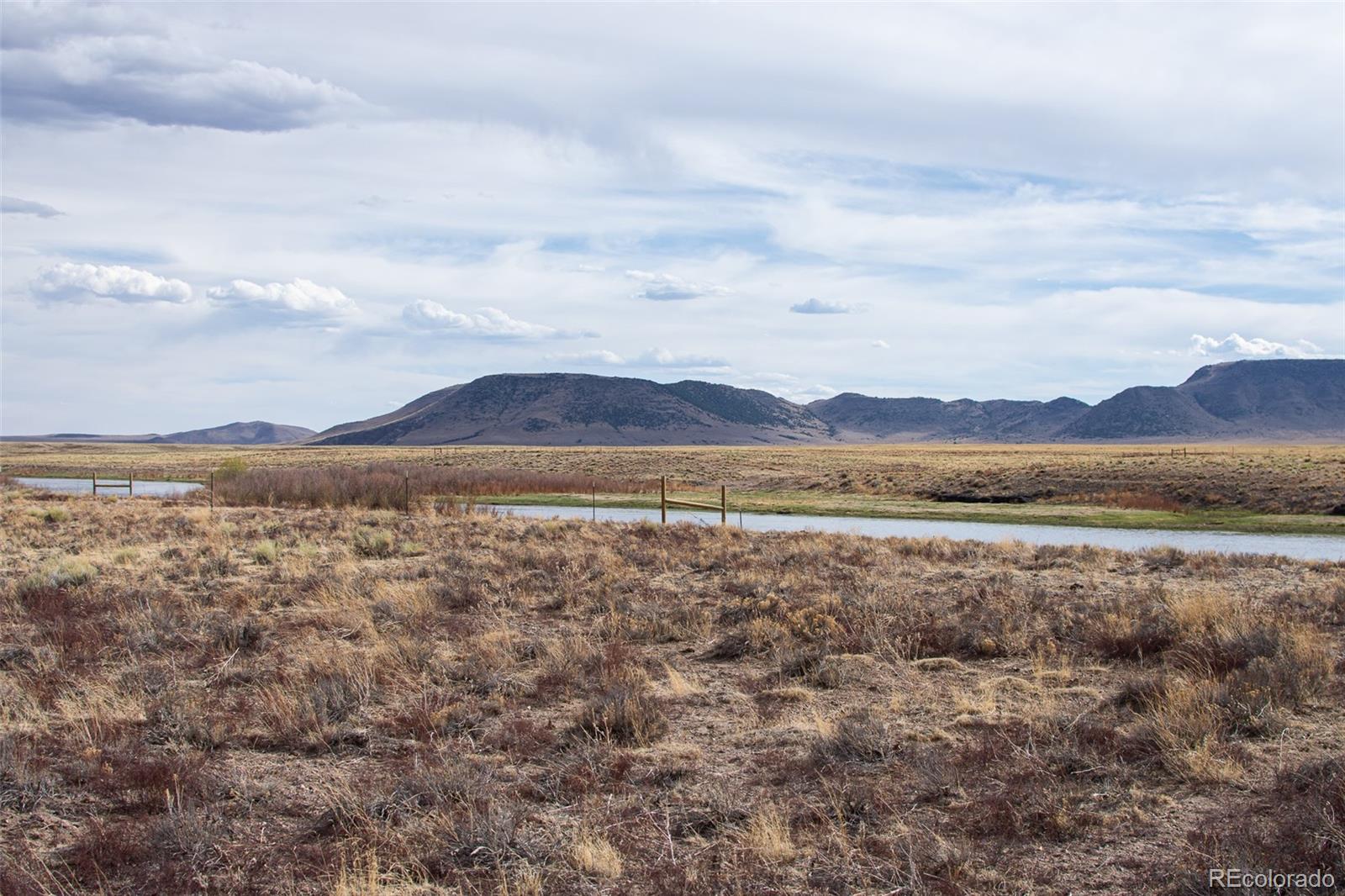 67 Kettledrum Road Sanford, CO 81151 - Photo 9 of 15 a view of a lake with sunset in the background