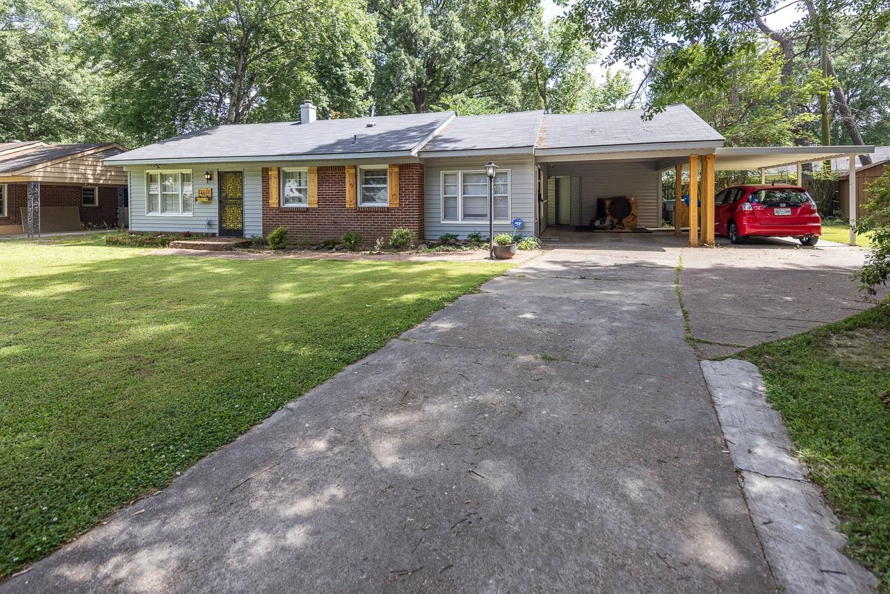 4611 Sea Isle Road Memphis, TN 38117 - Photo 1 of 24 a front view of a house with a garden and trees