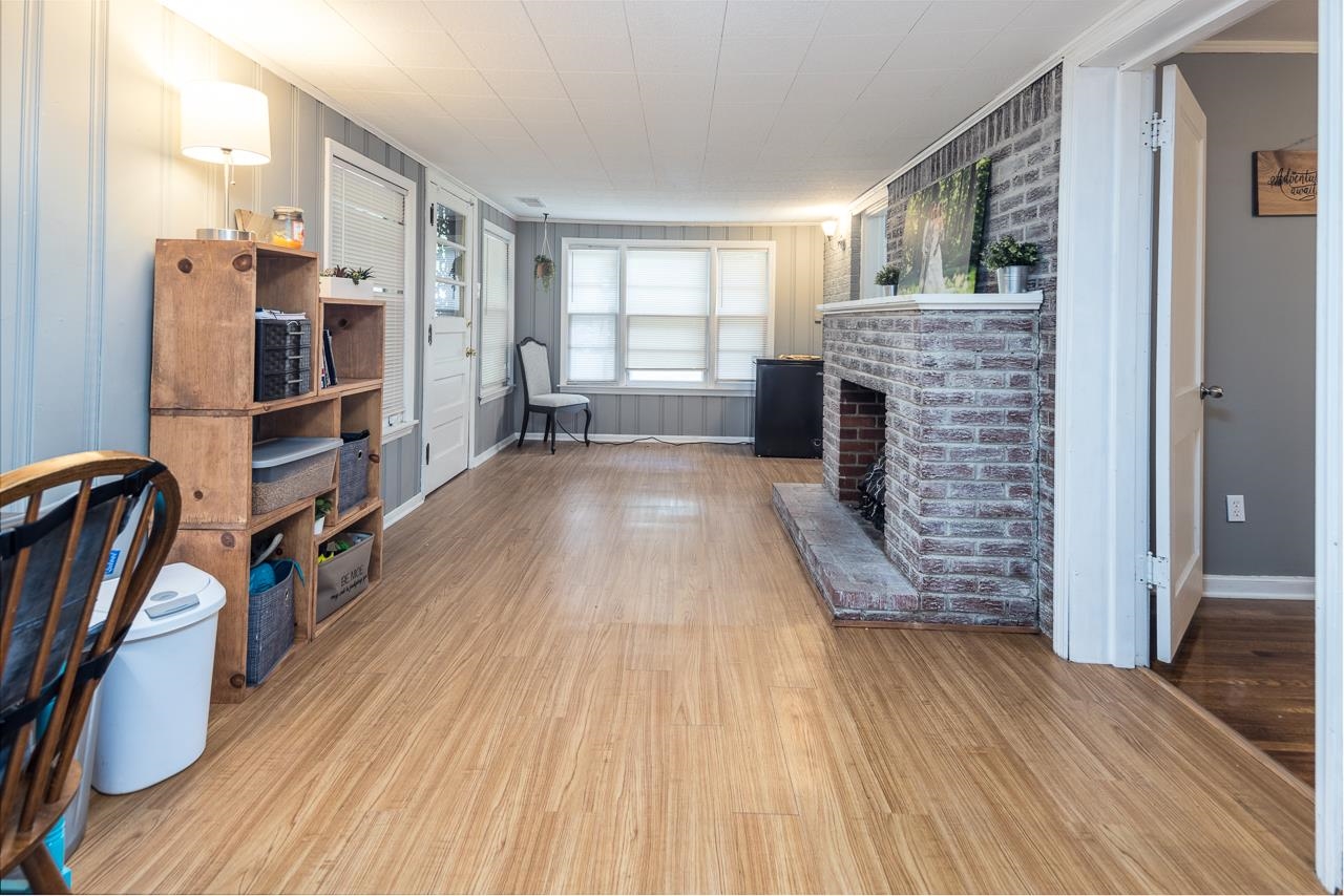4611 Sea Isle Road Memphis, TN 38117 - Photo 12 of 24 wooden floor in an empty room with a fireplace