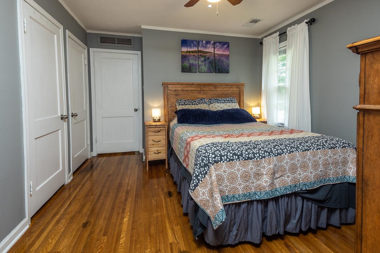 4611 Sea Isle Road Memphis, TN 38117 - Photo 15 of 24 a bedroom with a bed and wooden floor