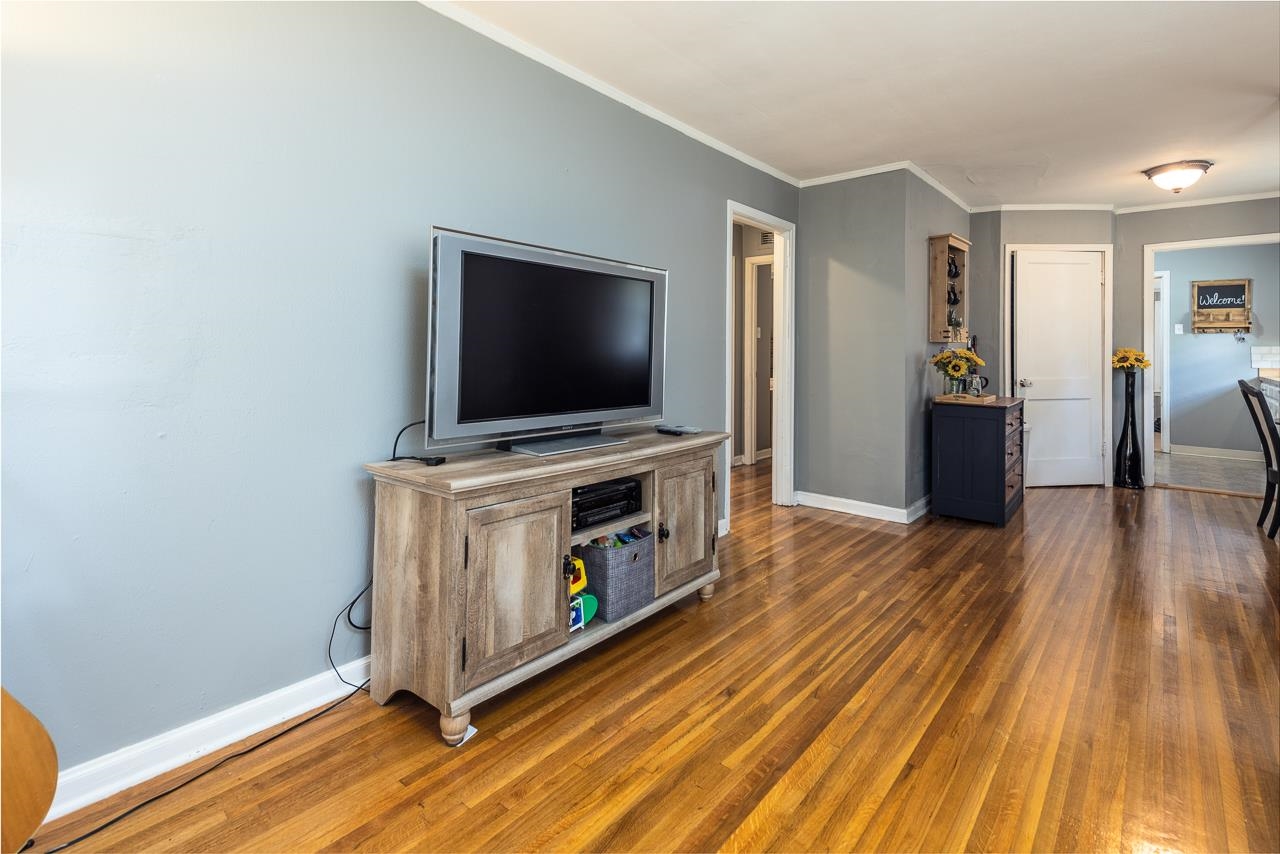4611 Sea Isle Road Memphis, TN 38117 - Photo 8 of 24 a view of a livingroom with wooden floor and a flat screen tv
