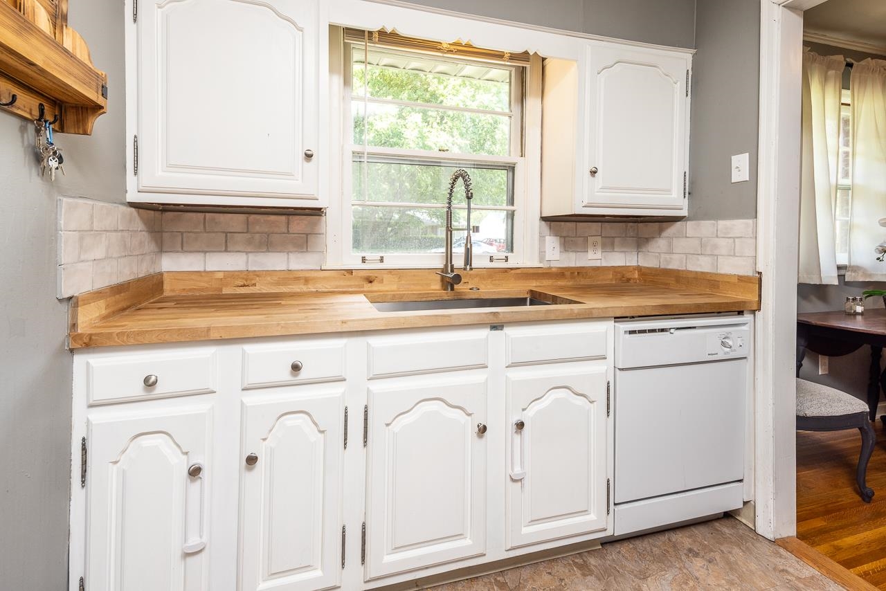 4611 Sea Isle Road Memphis, TN 38117 - Photo 10 of 24 a kitchen with granite countertop white cabinets and white appliances