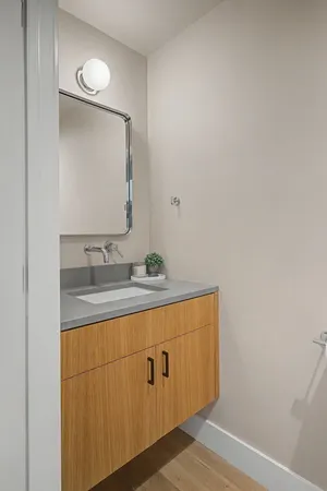 a bathroom with a sink a mirror and vanity