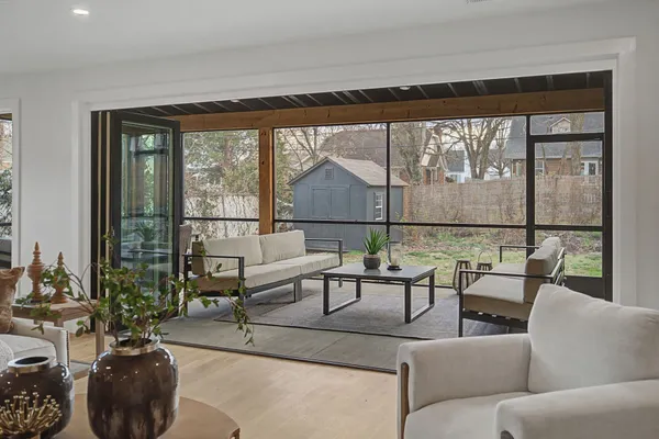 a living room with furniture and a floor to ceiling window
