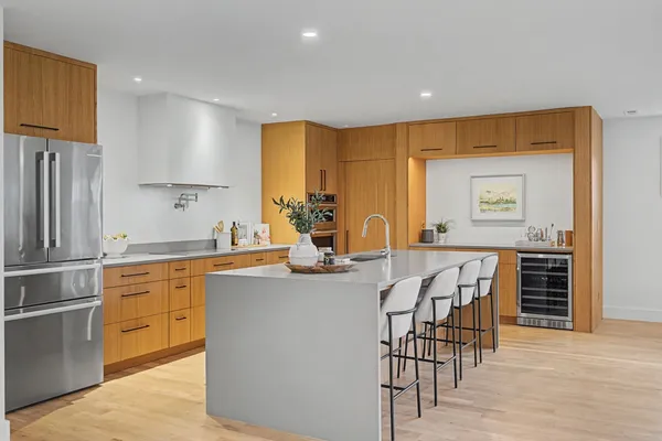 a kitchen with stainless steel appliances kitchen island granite countertop a sink and cabinets