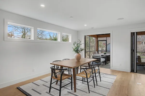 a view of a dining room with furniture and wooden floor