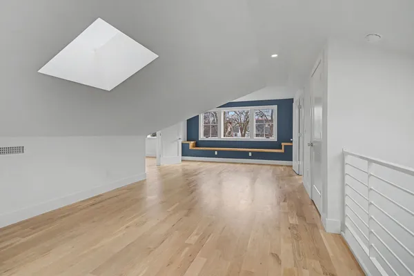 wooden floor in a hall with an empty room