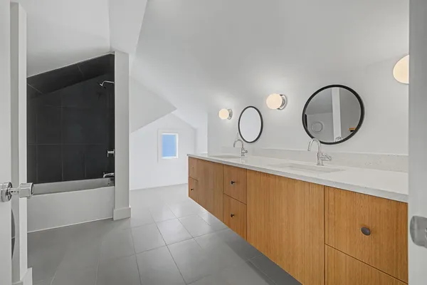 a bathroom with a double vanity sink and mirror