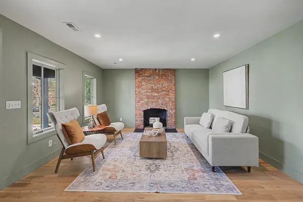 a living room with furniture and a fireplace