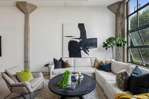 a living room with furniture and a potted plant