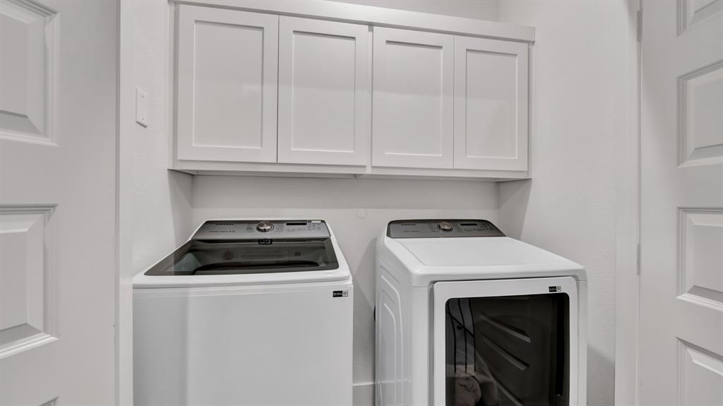 602 Winners Circle Rowlett, TX 75088 - Photo 27 of 35 Laundry area featuring white shaker-style cabinetry, white walls, and paneled doors