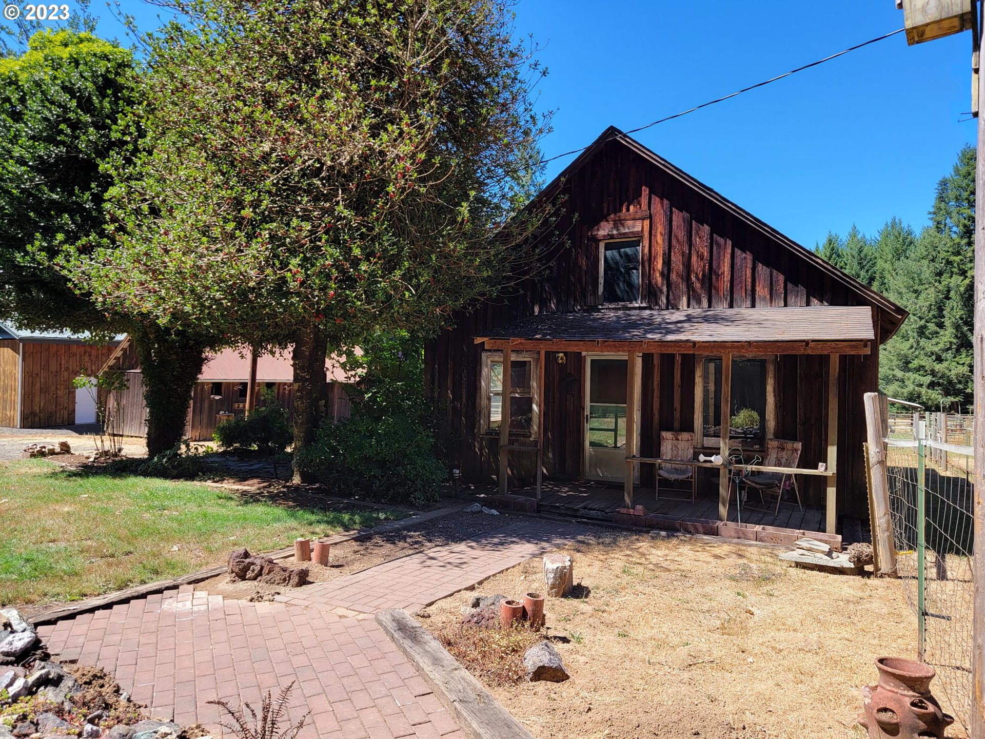 1080 Burma Road Camas Valley, OR 97416 - Photo 1 of 29 a front view of a house with garden