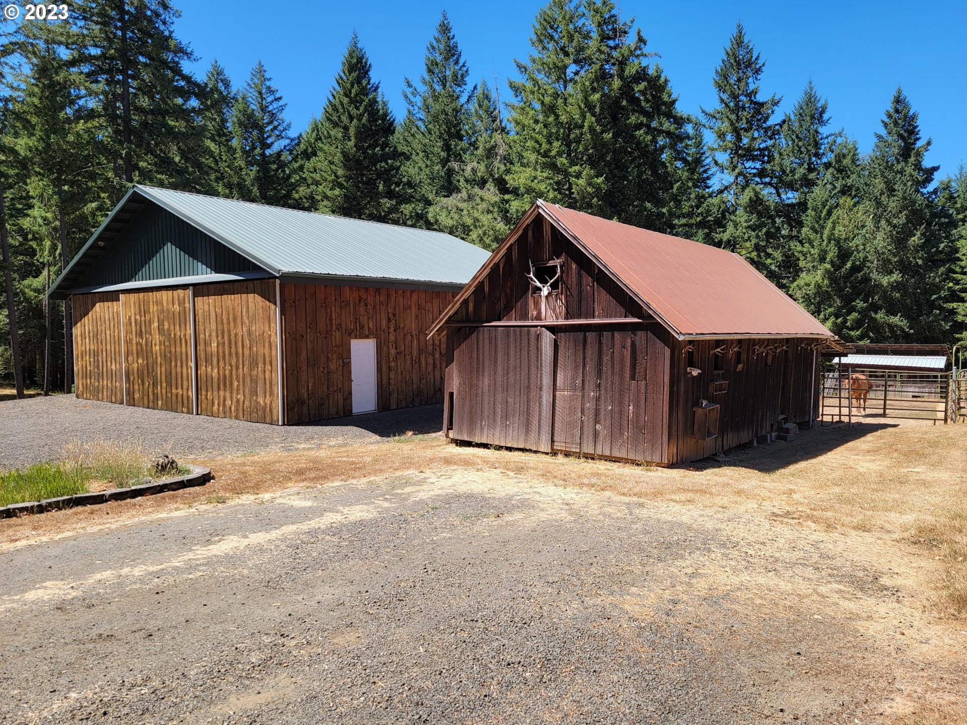 1080 Burma Road Camas Valley, OR 97416 - Photo 10 of 29 a front view of a house with a yard and garage