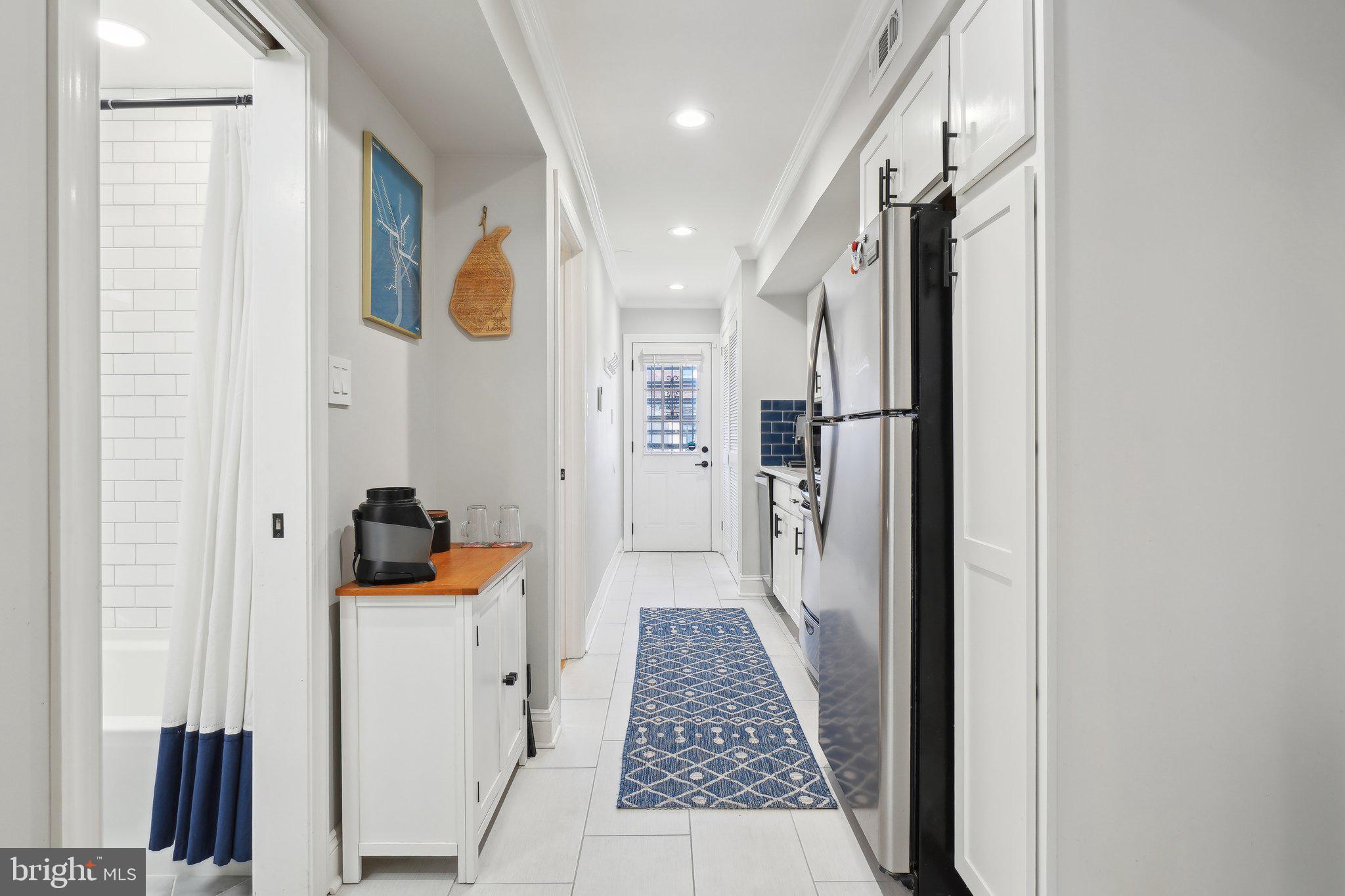 123 17th Street Southeast, Unit 2 Washington, DC 20003 - Photo 4 of 20 a walk in closet with wooden floor and a bathroom