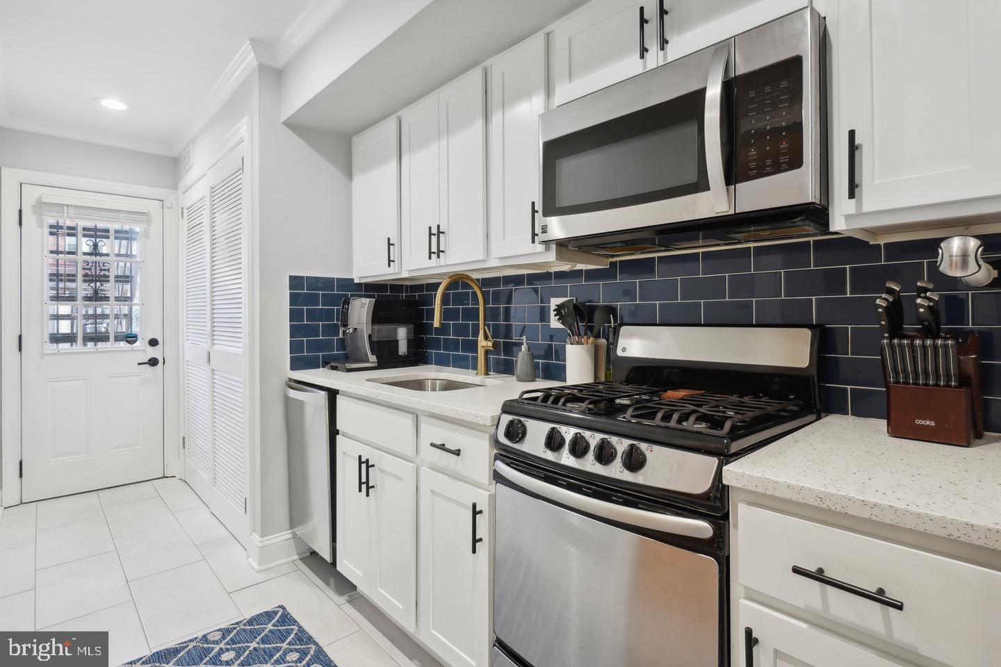 123 17th Street Southeast, Unit 2 Washington, DC 20003 - Photo 5 of 20 a kitchen with stainless steel appliances a stove a microwave and cabinets