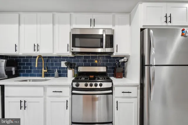 a kitchen with stainless steel appliances a stove and a refrigerator