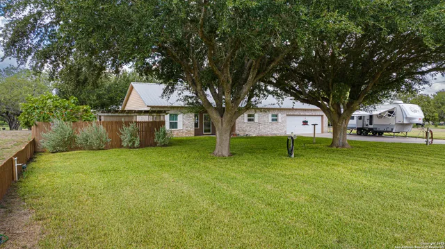 a house with huge green field in front of it