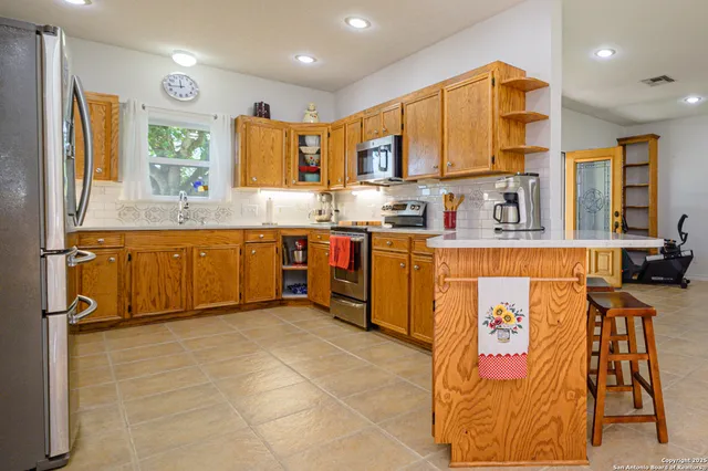 a kitchen with stainless steel appliances granite countertop wooden cabinets a sink and dishwasher