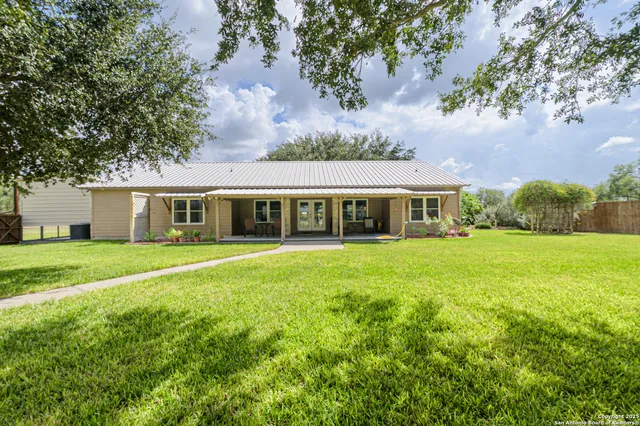 a front view of house with yard and green space
