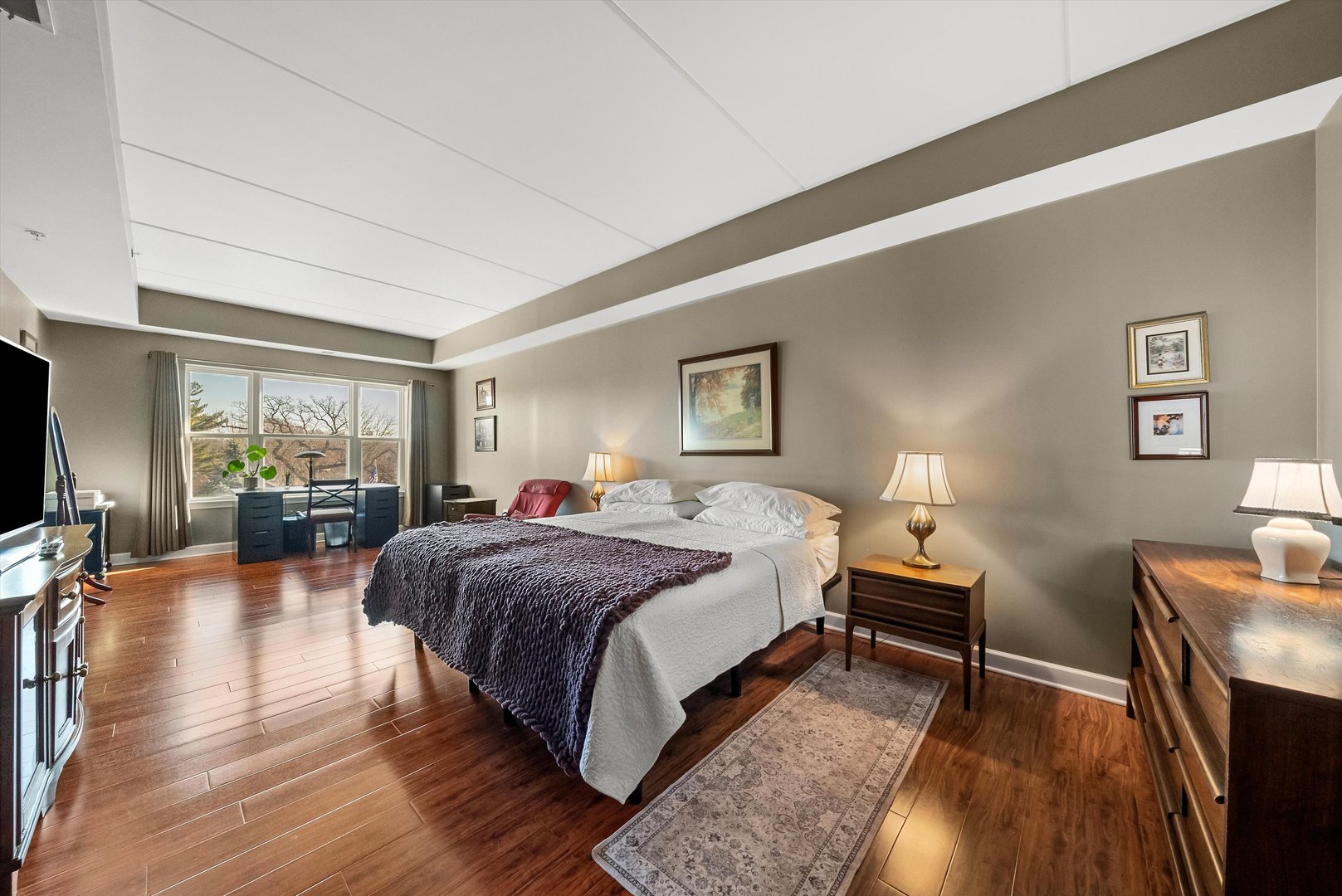 10 North Gilbert Street, Unit 314 South Elgin, IL 60177 - Photo 12 of 25 a spacious bedroom with a bed a couch and dresser