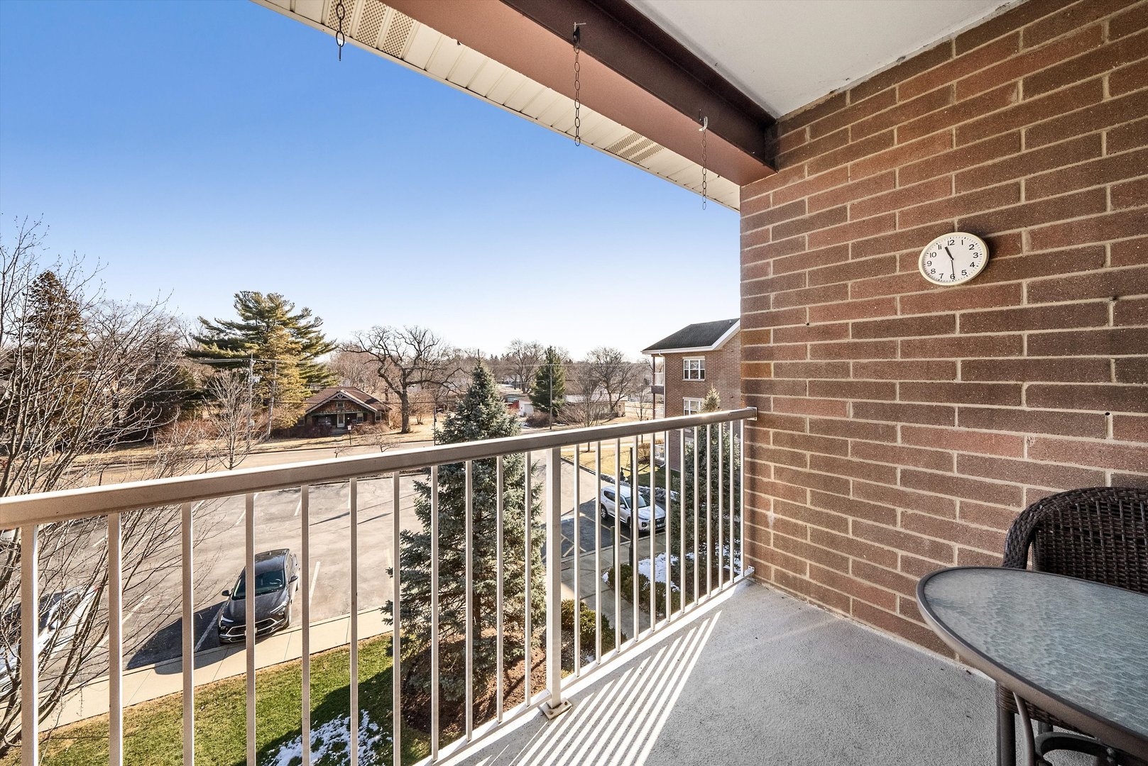 10 North Gilbert Street, Unit 314 South Elgin, IL 60177 - Photo 22 of 25 a view of a balcony with a chair and wooden floor