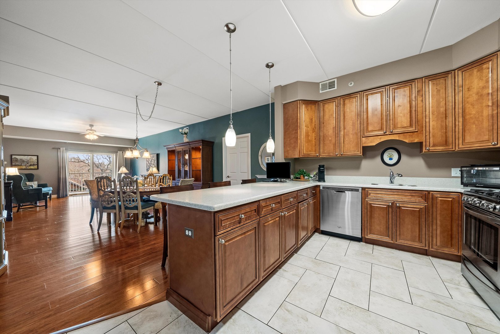 10 North Gilbert Street, Unit 314 South Elgin, IL 60177 - Photo 5 of 25 a kitchen with stainless steel appliances granite countertop a stove a sink dishwasher and a microwave oven with cabinets