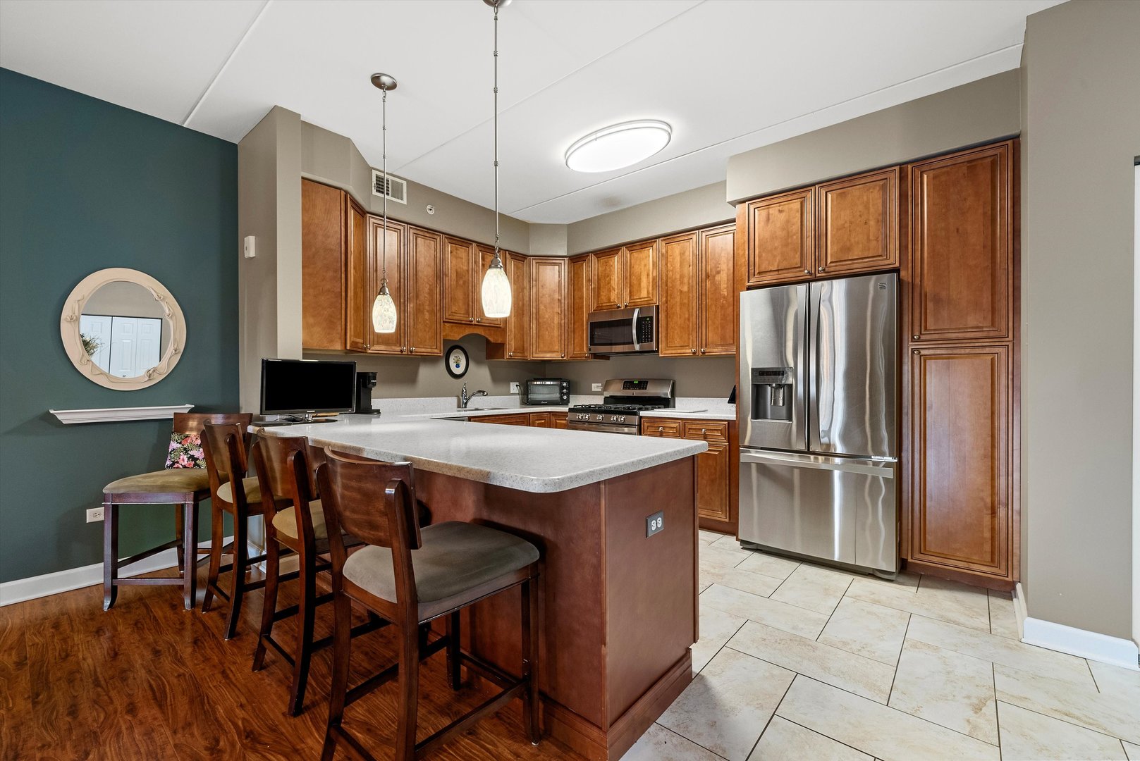 10 North Gilbert Street, Unit 314 South Elgin, IL 60177 - Photo 7 of 25 a kitchen with stainless steel appliances granite countertop a table chairs and a refrigerator