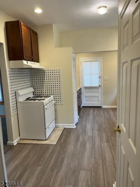 123 Clark Street Dover, NJ 07801 - Photo 2 of 12 a view of a kitchen with wooden floor and electronic appliances