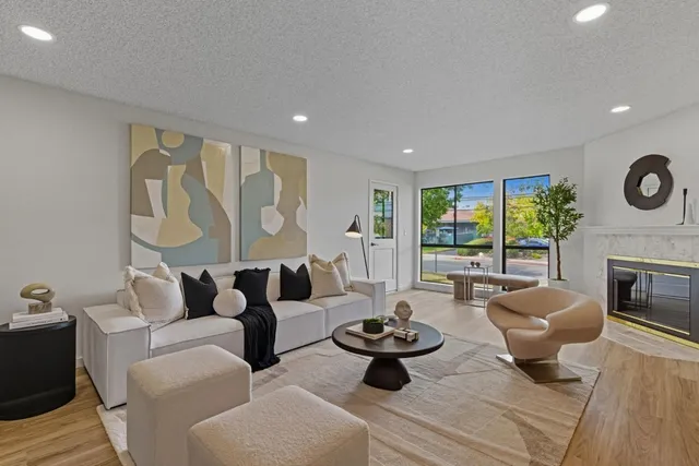 a living room with furniture fireplace and window