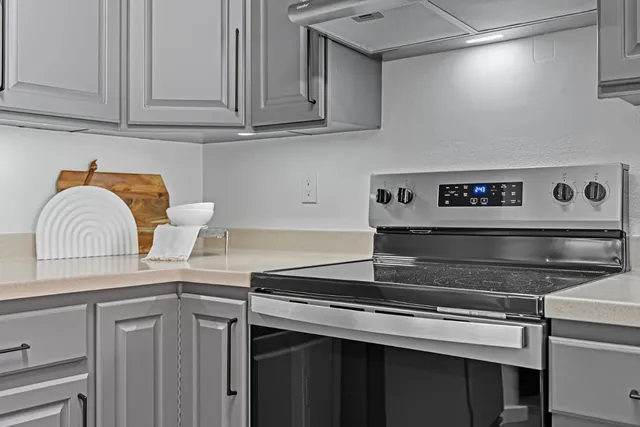 a kitchen with granite countertop a stove and a sink