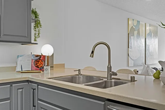 a kitchen with a sink and a wooden floor