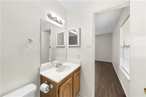 a bathroom with a sink a light fixture and a mirror