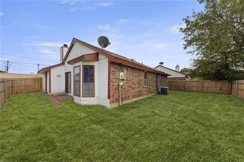 a view of a house with a yard and sitting area