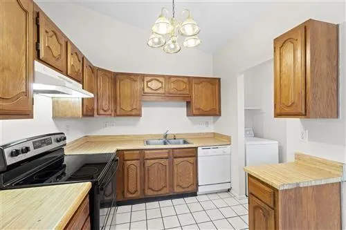 a kitchen with a sink dishwasher a stove and a refrigerator with wooden floor