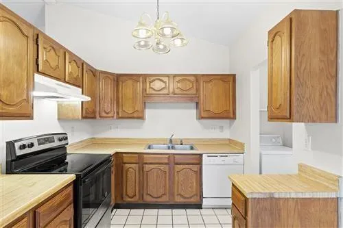 a kitchen with a sink cabinets and window