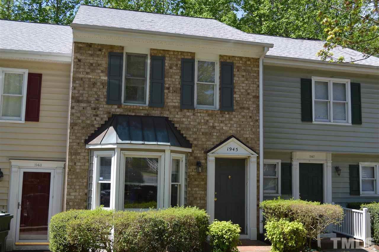 a view of a brick house with a large windows and large windows