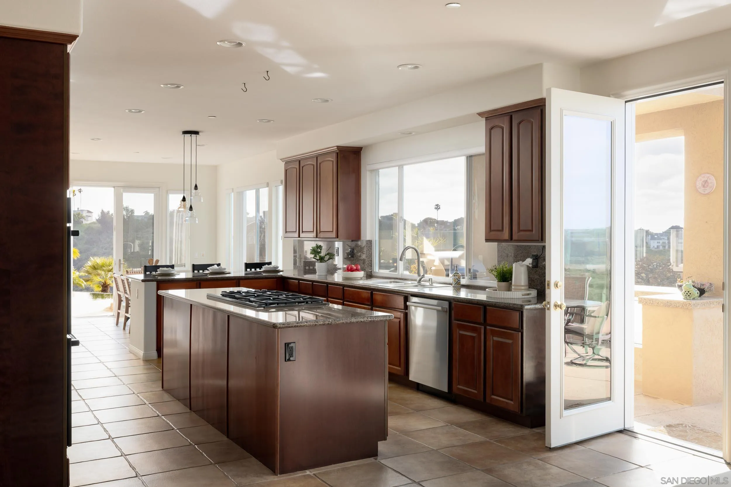1786 Swallowtail Road Encinitas, CA 92024 - Photo 13 of 46 a kitchen with stainless steel appliances granite countertop a stove a sink and a refrigerator