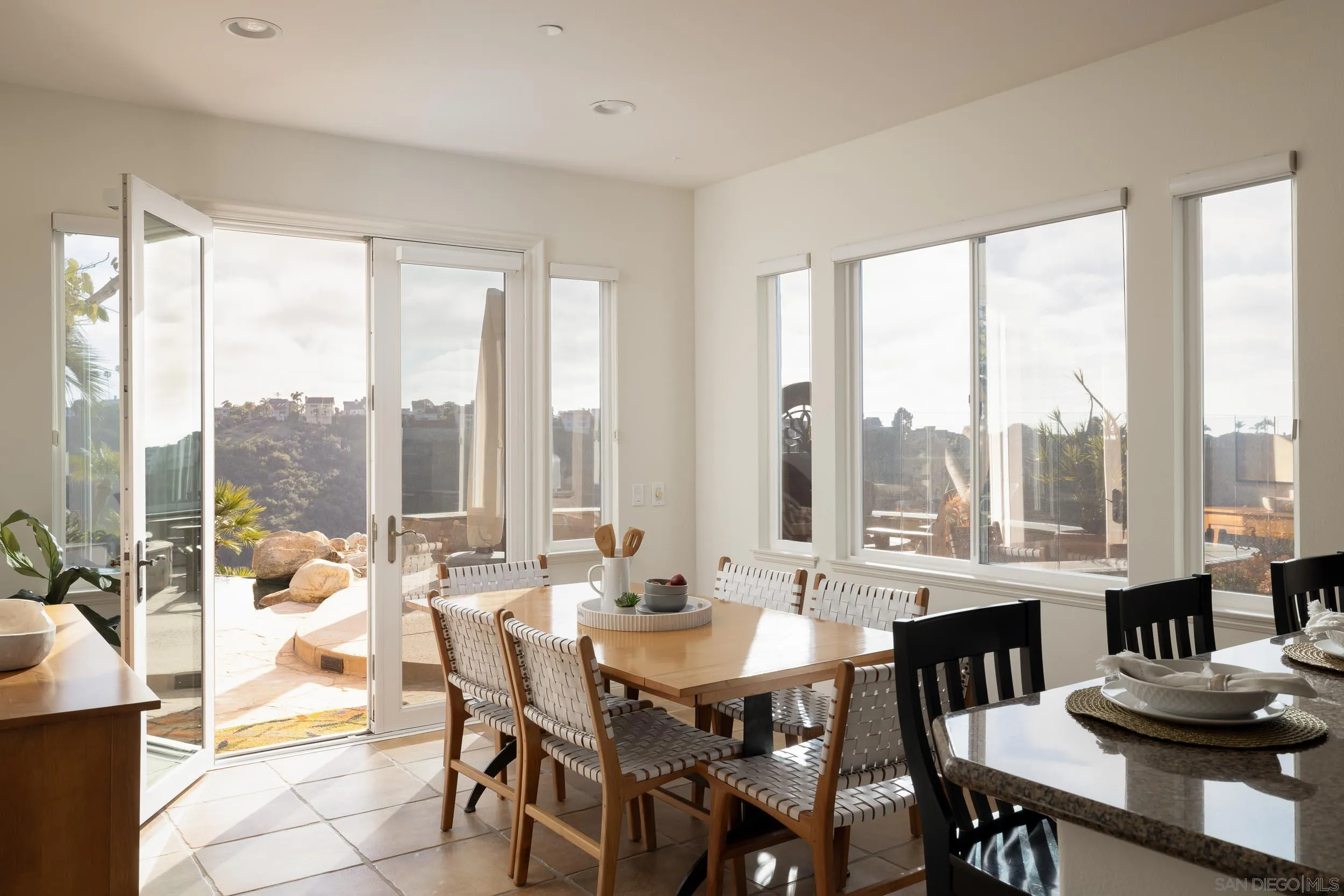1786 Swallowtail Road Encinitas, CA 92024 - Photo 14 of 46 a view of a dining room with furniture and a large window