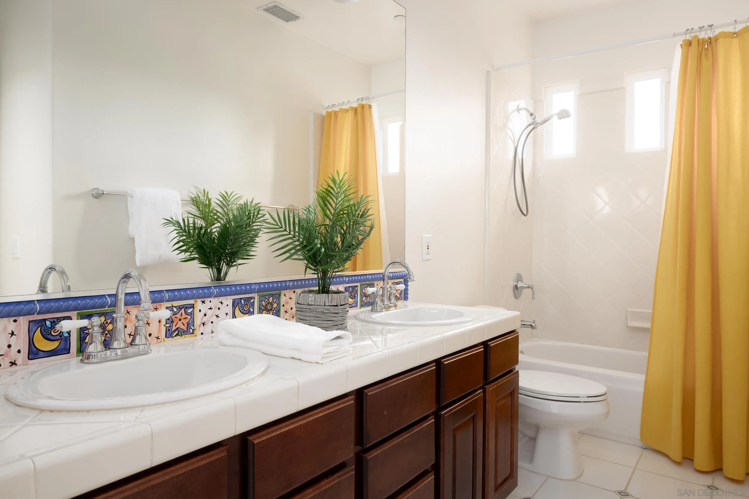 1786 Swallowtail Road Encinitas, CA 92024 - Photo 23 of 46 a bathroom with a sink and a mirror