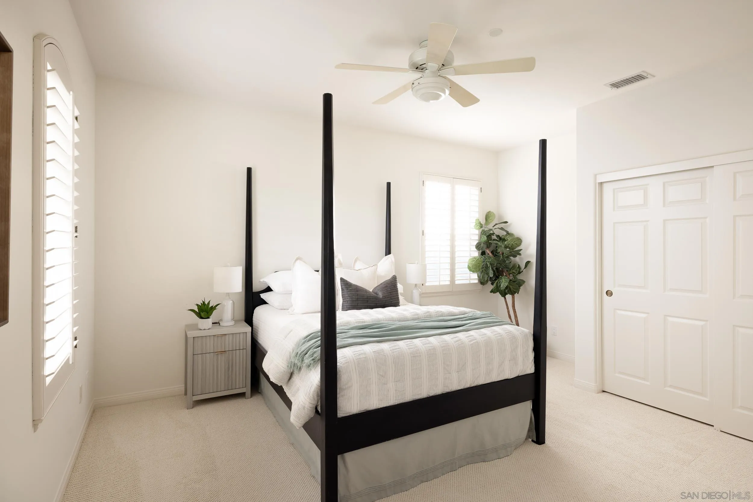 1786 Swallowtail Road Encinitas, CA 92024 - Photo 25 of 46 a bedroom with a large bed and a chandelier