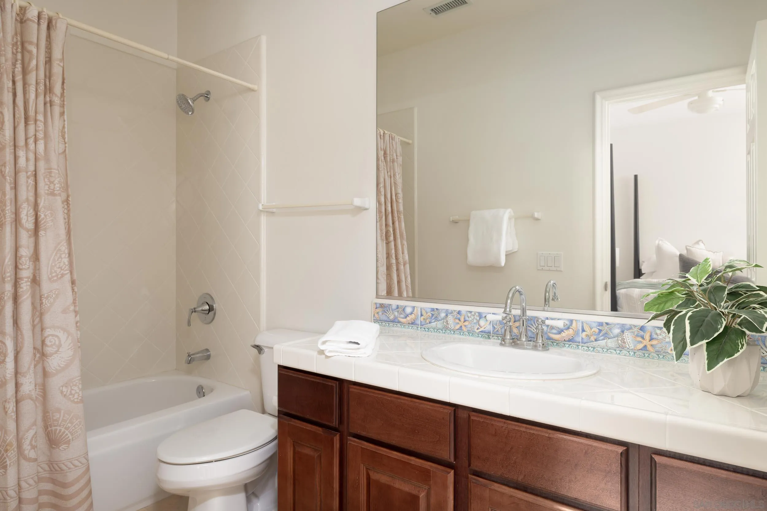 1786 Swallowtail Road Encinitas, CA 92024 - Photo 26 of 46 a bathroom with a granite countertop sink a toilet and shower