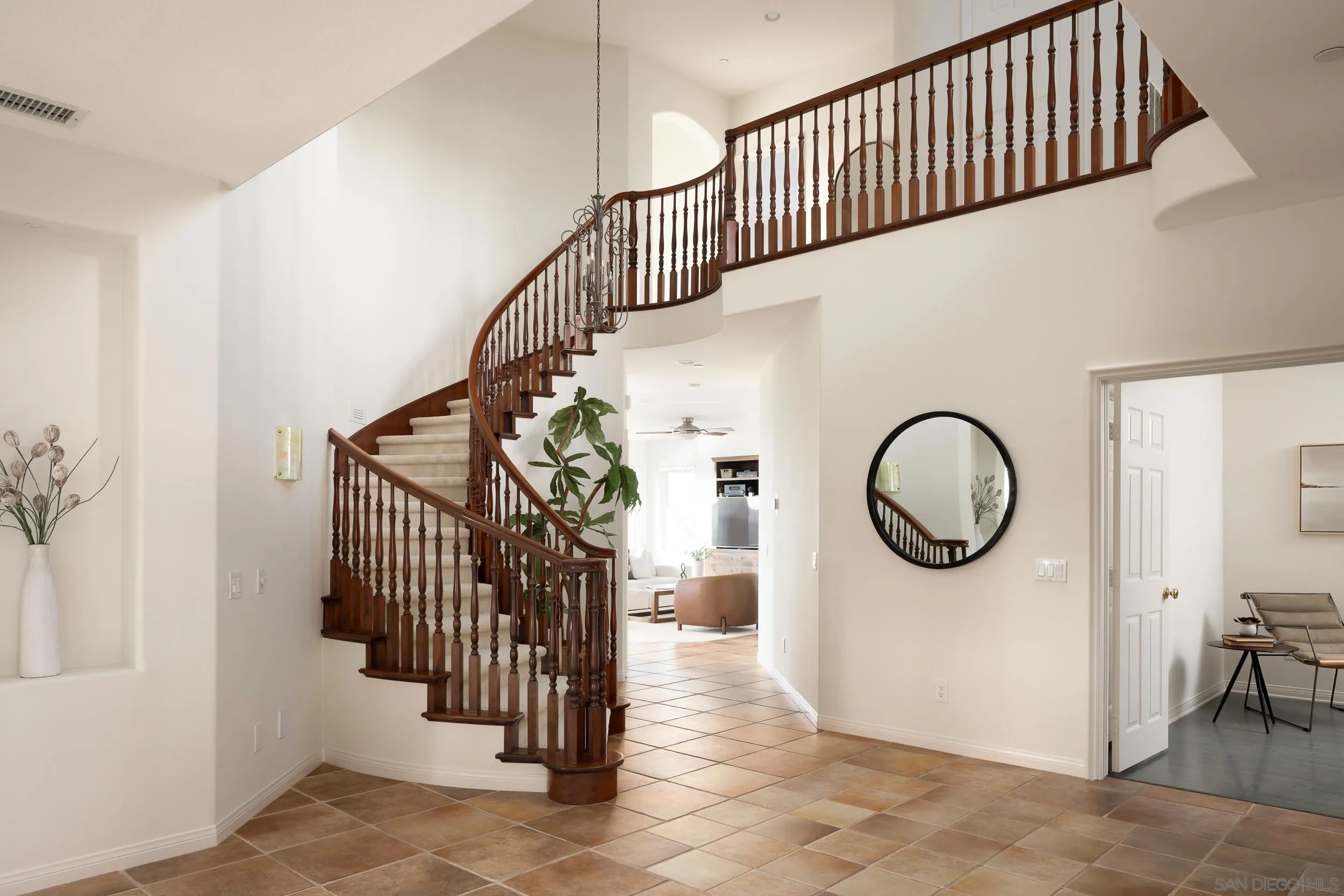 1786 Swallowtail Road Encinitas, CA 92024 - Photo 7 of 46 a view of a hallway with entryway wooden floor and a chandelier