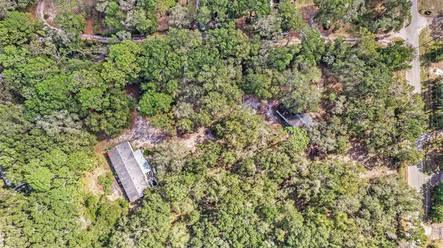 a aerial view of a houses with a yard
