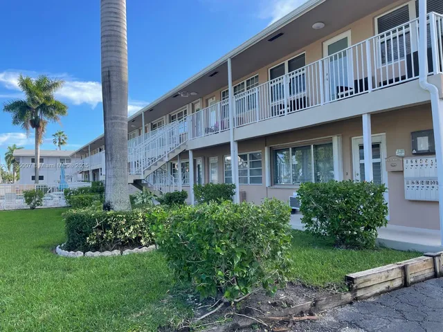 a front view of a building with garden