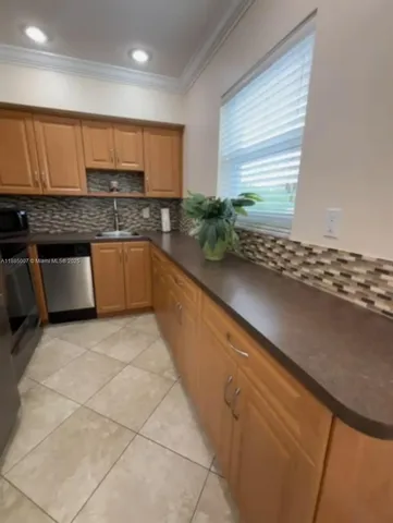 a kitchen with stainless steel appliances a sink stove and cabinets