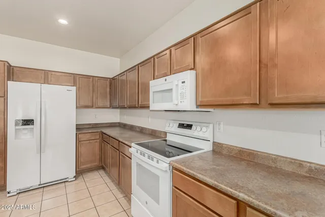 a kitchen with cabinets appliances and a counter space