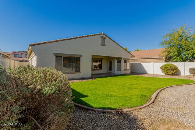 a view of a house with a backyard